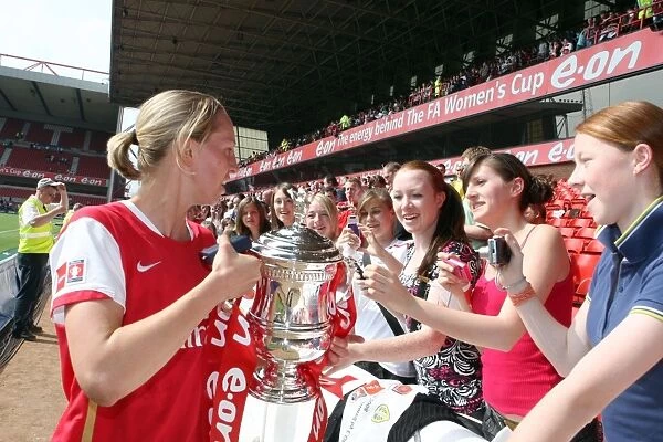 Faye White (Arsenal) shows of the troph to the fans