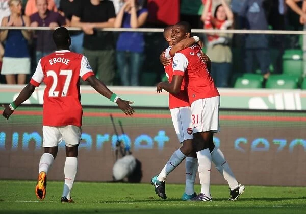 Five-Star Celebration: Jay Emmanuel Thomas, Kieran Gibbs, and Emmanuel Eboue Rejoice in Arsenal's 5-Goal Blitz Against Legia Warsaw