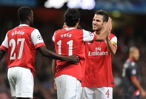 Five-Star Celebration: Vela, Eboue, and Fabregas Rejoice in Arsenal's 6-0 Victory over SC Braga