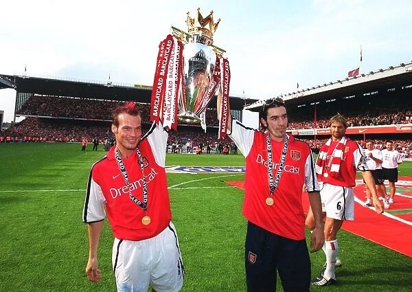 Fredrik Ljungberg and Robert Pires (Arsenal) lift the F.A