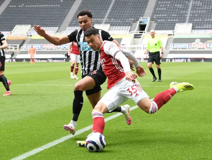 Framed Print : Gabriel Martinelli vs. Jacob Murphy: A Battle at Empty St. James Park - Newcastle United vs. Arsenal, Premier League 2021