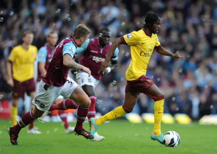 Framed Print : Gervinho vs. George McCartney: A Battle in the 2012-13 Premier League Clash Between West Ham and Arsenal