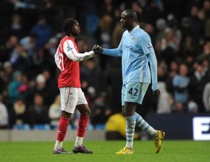 Framed Print : Gervinho and Yaya Toure: A Moment of Sportsmanship Amidst Manchester City vs. Arsenal Rivalry (2011-12)