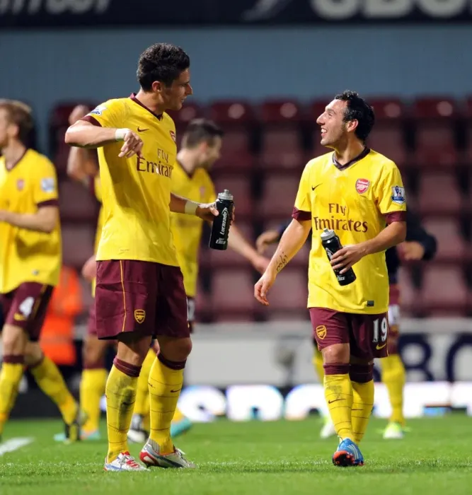 Framed Print : Giroud and Cazorla: A Moment of Connection after West Ham vs. Arsenal (2012-13)