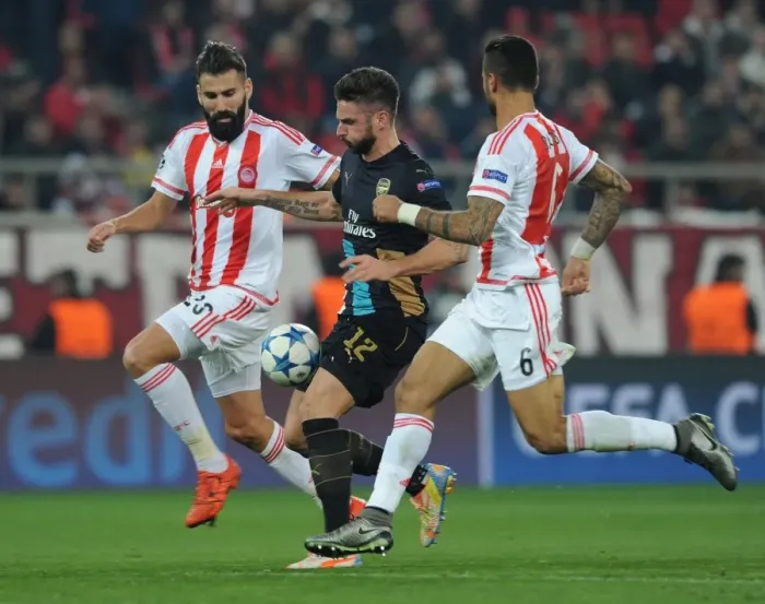 Framed Print : Giroud Goes Head-to-Head with Siovas and da Costa in Olympiacos vs Arsenal UEFA Champions League Clash Framed Print : Giroud Goes Head-to-Head with Siovas and da Costa in Olympiacos vs Arsenal UEFA Champions League Clash