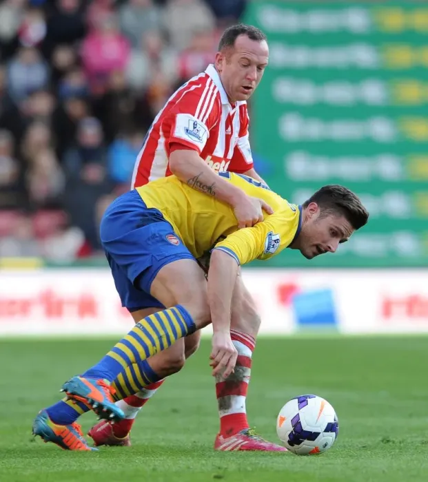 Framed Print : Giroud vs. Adam: Intense Battle in Stoke City vs. Arsenal Premier League Clash