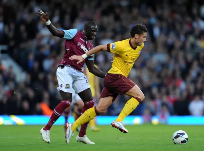 Framed Print : Giroud vs Diame: Battle at the Boleyn Ground - Arsenal vs West Ham United, Premier League 2012-13