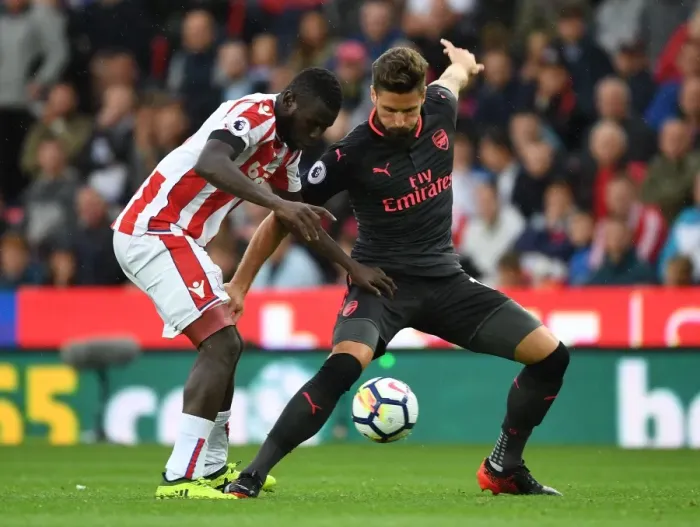 Framed Print : Giroud vs Diouf: A Battle at Bet365 Stadium - Stoke City vs Arsenal, Premier League 2017-18