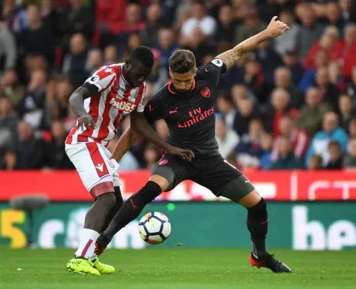 Framed Print : Giroud vs Diouf: Clash at the Bet365 Stadium - Stoke City vs Arsenal, Premier League 2017-18