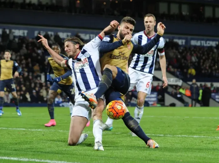 Framed Print : Giroud vs Evans: A Premier League Battle - Intense Tackle Between Arsenal's Star Forward and West Brom's Defender