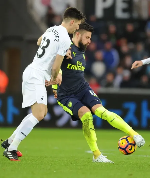 Framed Print : Giroud vs Fernandez: Intense Battle at Swansea's Liberty Stadium - Arsenal vs Swansea City, Premier League 2016-17
