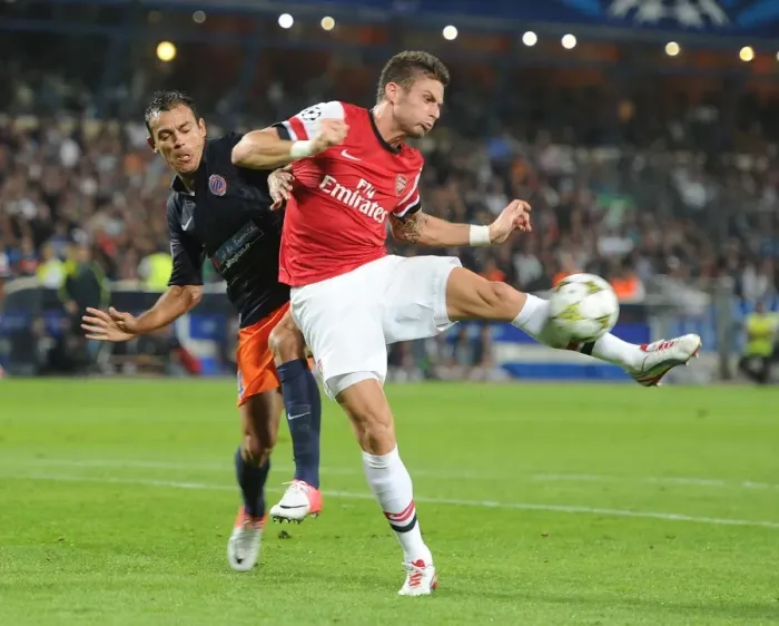 Framed Print : Giroud vs Hilton: Intense Battle in Montpellier v Arsenal UEFA Champions League Clash