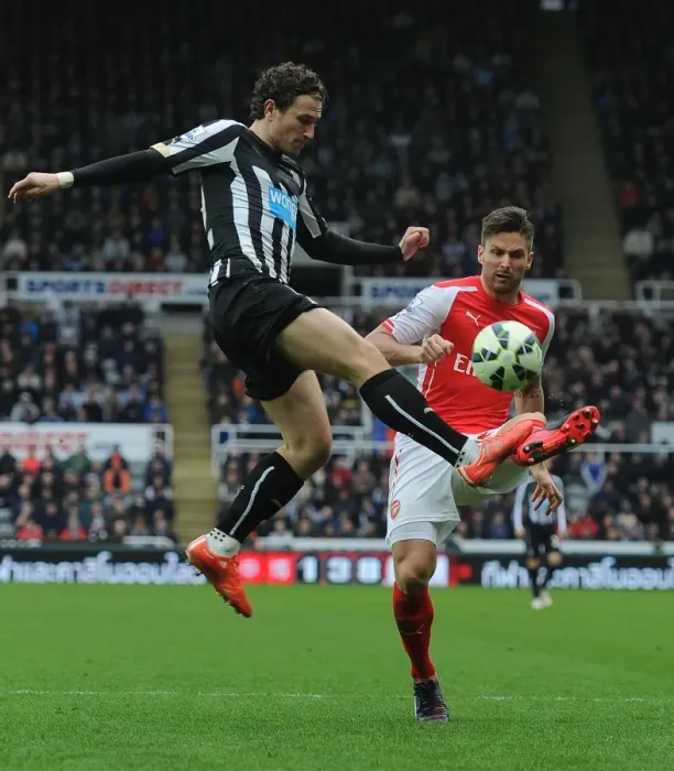 Framed Print : Giroud vs. Janmaat: Intense Clash Between Newcastle and Arsenal in Premier League