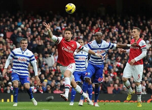 Giroud vs. Mbia: A Premier League Battle – Arsenal's Olivier Giroud and QPR's Stephane Mbia Clash at Emirates Stadium