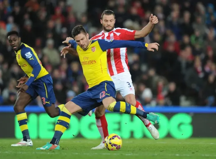 Framed Print : Giroud vs Pieters: Intense Battle at the Britannia Stadium - Stoke City vs Arsenal, Premier League 2014-15