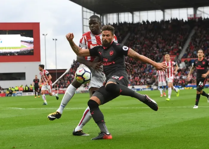 Framed Print : Giroud vs Zouma: Intense Battle at Stoke City vs Arsenal, Premier League 2017-18