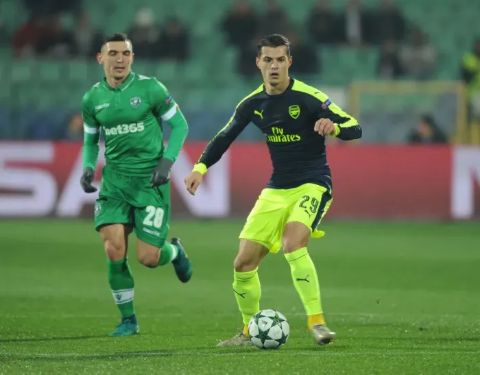 Framed Print : Granit Xhaka Breaks Past Ludogorets Claudiu Keseru in Arsenal's UEFA Champions League Clash