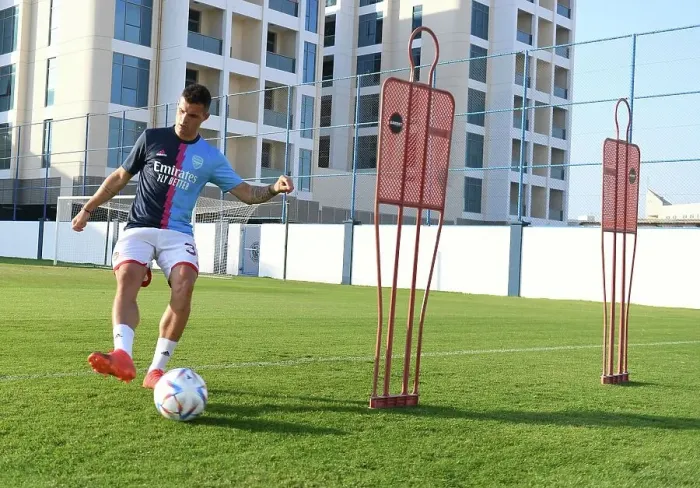 Framed Print : Granit Xhaka Prepares for Arsenal vs AC Milan: Arsenal Football Club's Training Session, Dubai Super Cup 2022