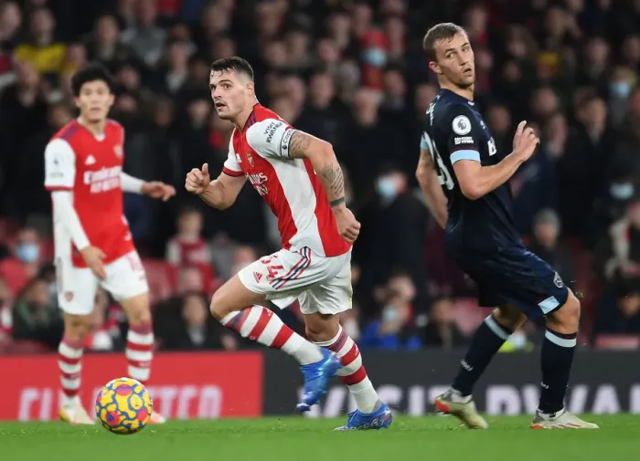 Framed Print : Granit Xhaka Surges Past West Ham's Alex Kral in Arsenal's Premier League Clash