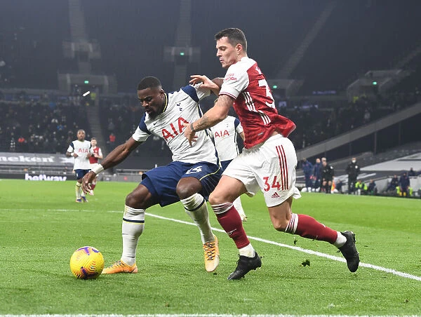 Granit Xhaka vs. Serge Aurier: Battle in the Premier League Clash Between Tottenham and Arsenal, London, 2020