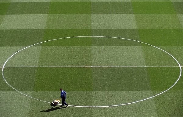 Groundsman Paul Burgess marks out the pitch before the match