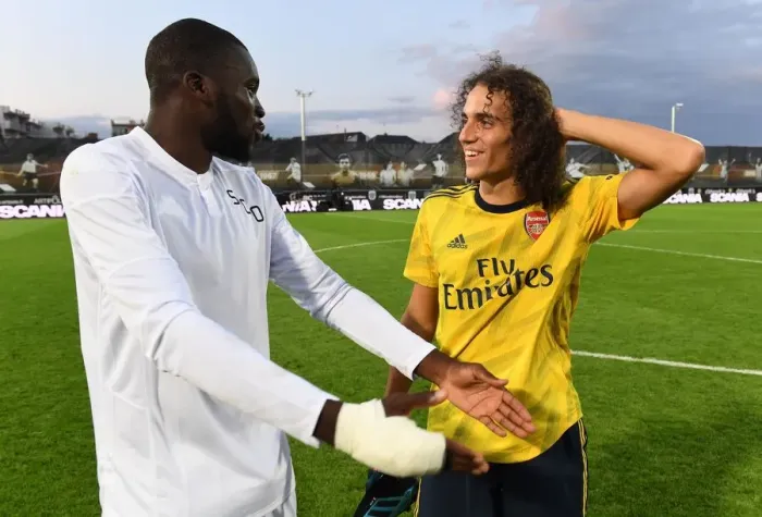 Framed Print : Guendouzi and Kanga Share a Moment After Angers vs. Arsenal Pre-Season Friendly