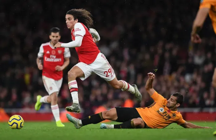 Framed Print : Guendouzi Soars: Arsenal's Matteo Jumps Over Cutrone in Premier League Clash vs. Wolverhampton