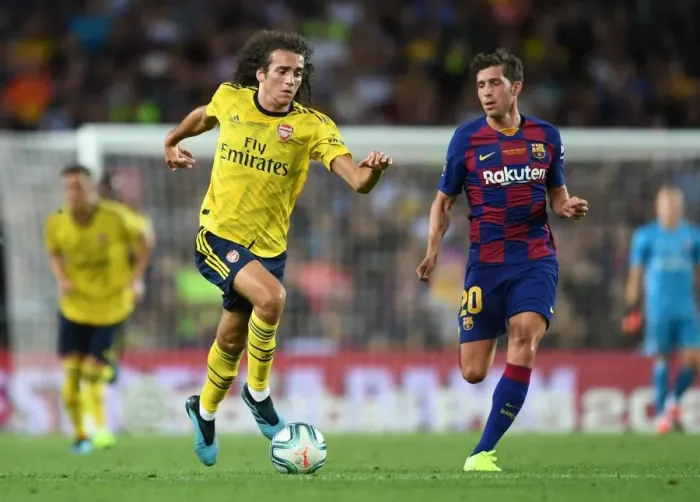 Framed Print : Guendouzi vs. Sergi Roberto: A Clash of Midfield Titans in FC Barcelona vs. Arsenal Pre-Season Clash at Nou Camp (2019)