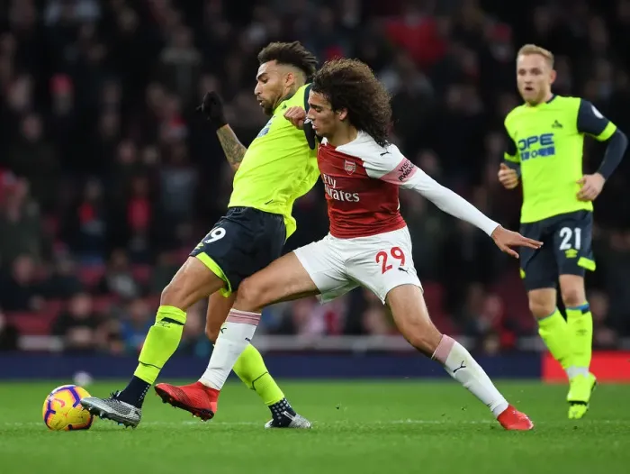 Framed Print : Guendouzi vs Williams: Intense Clash Between Arsenal's Matteo Guendouzi and Huddersfield's Danny Williams in the Premier League Framed Print : Guendouzi vs Williams: Intense Clash Between Arsenal's Matteo Guendouzi and Huddersfield's Danny Williams in the Premier League