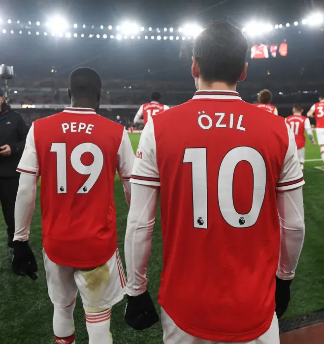 Framed Print : Half Time at Emirates: Pepe and Ozil of Arsenal Discuss Strategy with Manchester United (2019-20) Framed Print : Half Time at Emirates: Pepe and Ozil of Arsenal Discuss Strategy with Manchester United (2019-20)