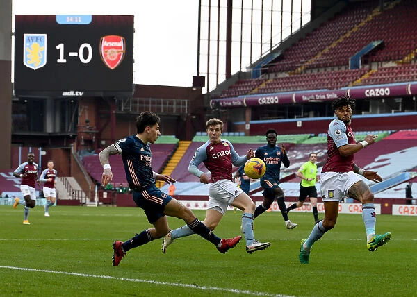 Hector Bellerin Faces Pressure from Villa Defenders During Arsenal's Premier League Clash