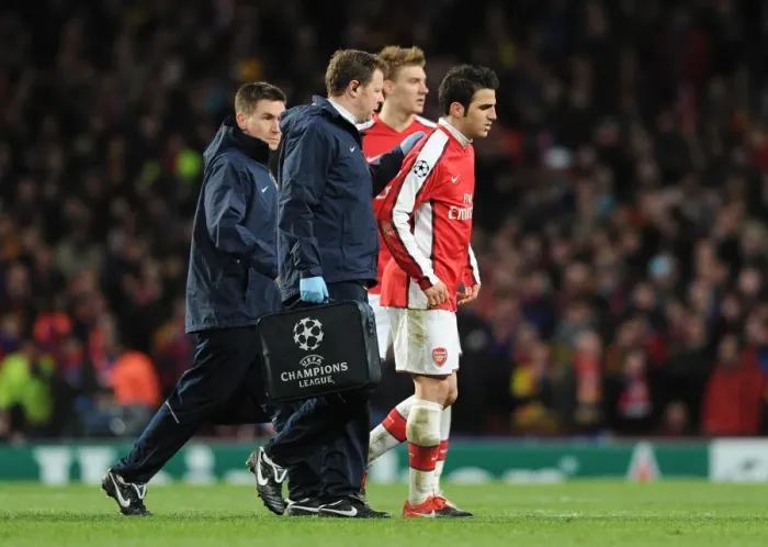 Framed Print : Injured Arsenal captain Cesc Fabregas limps off the pitch. Arsenal 2: 2 Barcelona