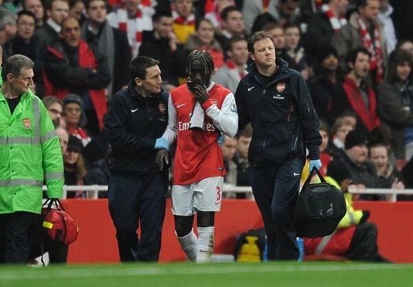 Injured Arsenal defender Bacary Sagna with physio Colin Lewin and doctor Gary O Driscoll