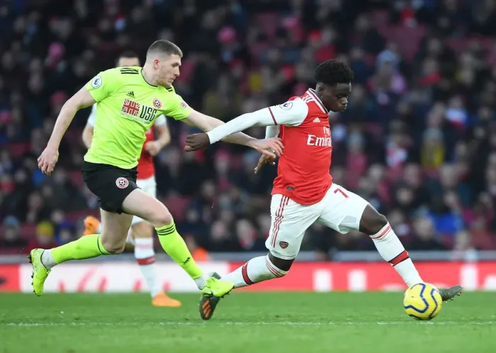 Framed Print : Intense Battle: Bukayo Saka vs. John Lundstram in Arsenal's Clash Against Sheffield United Framed Print : Intense Battle: Bukayo Saka vs. John Lundstram in Arsenal's Clash Against Sheffield United