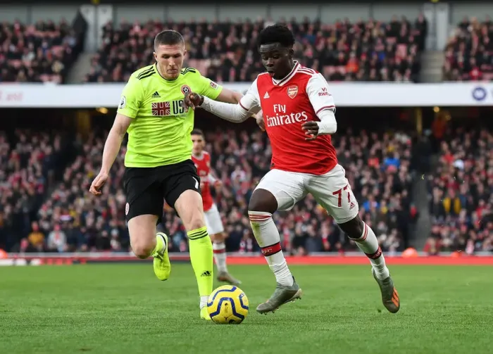 Framed Print : Intense Battle: Bukayo Saka vs. John Lundstram - Arsenal's Clash Against Sheffield United