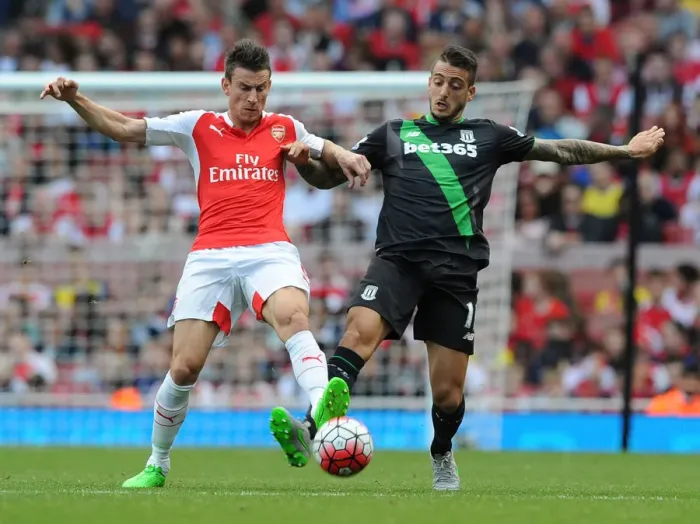 Framed Print : Intense Battle: Koscielny Tackles Joselu in Arsenal vs Stoke City (2015-16)