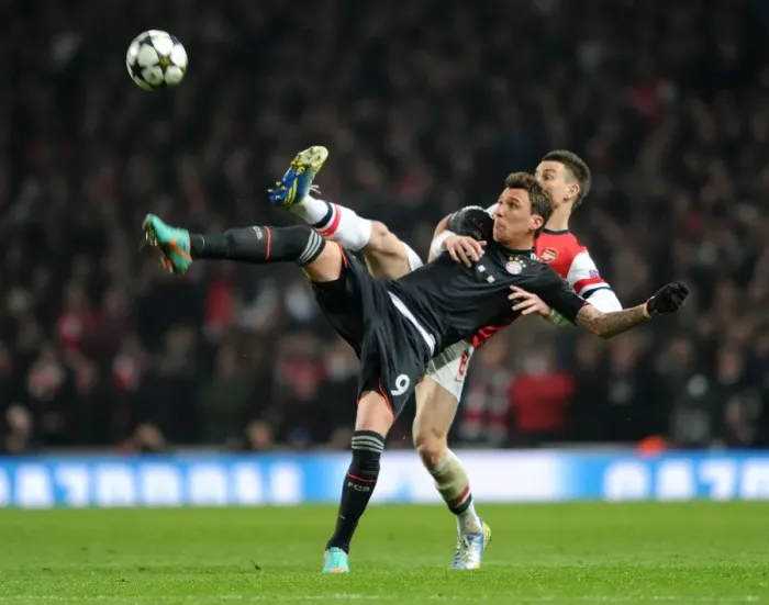 Framed Print : Intense Battle: Koscielny vs. Mandzukic in Arsenal's Champions League Showdown against Bayern Munich Framed Print : Intense Battle: Koscielny vs. Mandzukic in Arsenal's Champions League Showdown against Bayern Munich