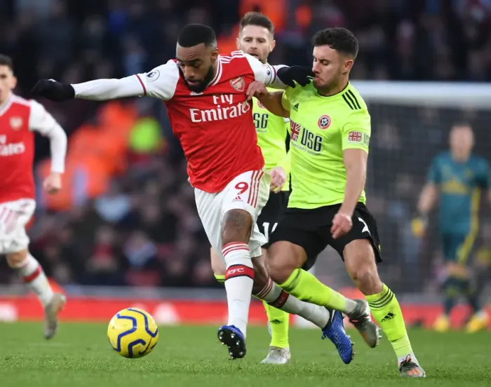 Framed Print : Intense Battle: Lacazette vs Baldock in Arsenal vs Sheffield United Premier League Clash Framed Print : Intense Battle: Lacazette vs Baldock in Arsenal vs Sheffield United Premier League Clash