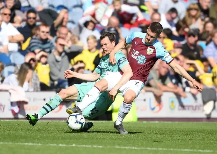Framed Print : Intense Battle: Lichtsteiner vs. Gudmundsson - Premier League Clash between Burnley and Arsenal Framed Print : Intense Battle: Lichtsteiner vs. Gudmundsson - Premier League Clash between Burnley and Arsenal