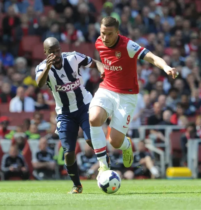 Framed Print : Intense Battle: Lukas Podolski vs Youssouf Mulumbu - Arsenal v West Bromwich Albion, Premier League Framed Print : Intense Battle: Lukas Podolski vs Youssouf Mulumbu - Arsenal v West Bromwich Albion, Premier League