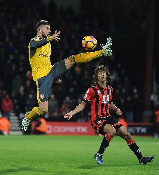 Intense Battle: Olivier Giroud vs. Nathan Ake in the Premier League Clash between Arsenal and Bournemouth (2016-17)