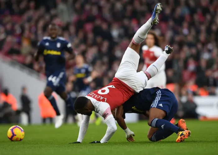 Framed Print : Intense Clash: Lacazette Fouls by Odoi in Arsenal vs. Fulham
