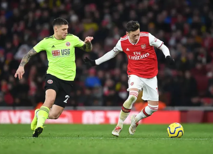 Framed Print : Intense Clash: Ozil vs. Baldock in Arsenal vs. Sheffield United Premier League Showdown