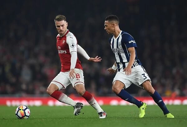 Intense Clash: Ramsey Fends Off Gibbs During Arsenal vs. West Bromwich Albion