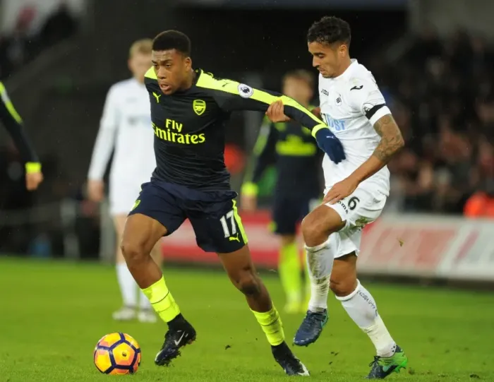 Framed Print : Intense Face-Off: Alex Iwobi vs. Kyle Naughton in Swansea vs. Arsenal Premier League Clash Framed Print : Intense Face-Off: Alex Iwobi vs. Kyle Naughton in Swansea vs. Arsenal Premier League Clash