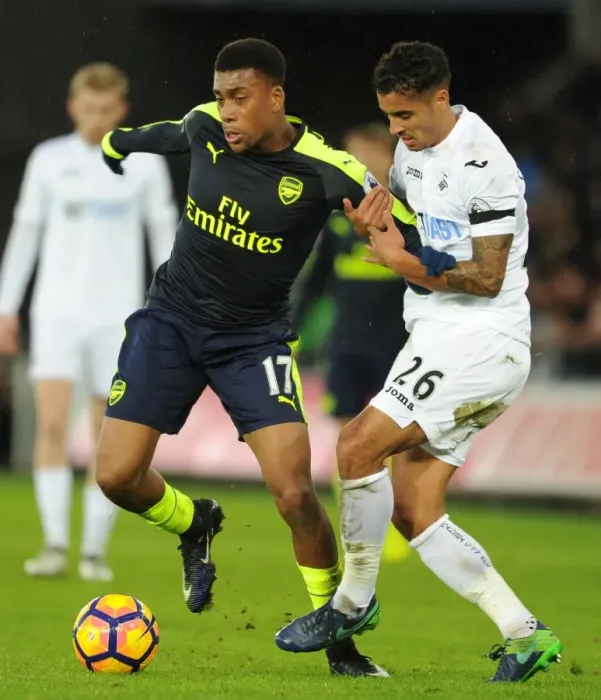 Framed Print : Intense Face-Off: Alex Iwobi vs Kyle Naughton - Swansea vs Arsenal Premier League Clash