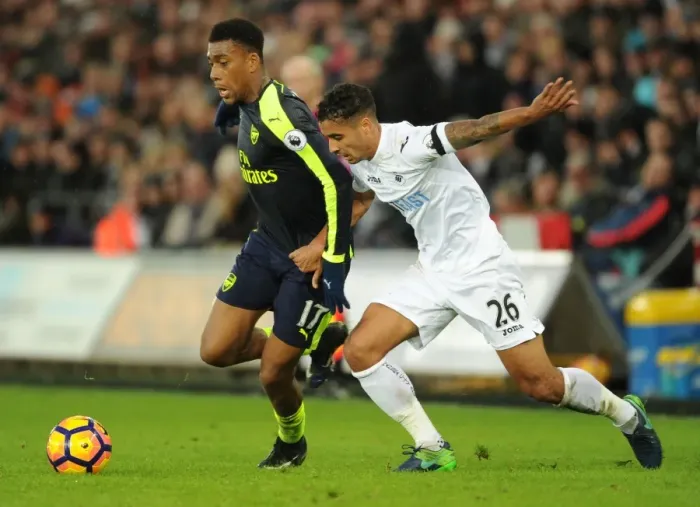 Framed Print : Intense Face-off: Alex Iwobi vs Kyle Naughton in Swansea vs Arsenal Premier League Clash Framed Print : Intense Face-off: Alex Iwobi vs Kyle Naughton in Swansea vs Arsenal Premier League Clash