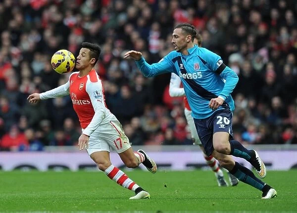 Intense Face-Off: Alexis Sanchez vs. Geoff Cameron - Arsenal's Battle Against Stoke City