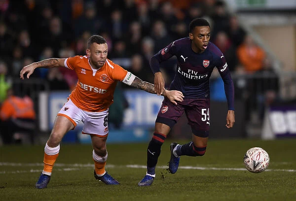 Intense Face-Off: Joe Willock vs. Jay Spearing in Arsenal's FA Cup Battle at Blackpool
