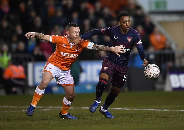 Intense Face-Off: Joe Willock vs. Jay Spearing in Arsenal's FA Cup Battle against Blackpool
